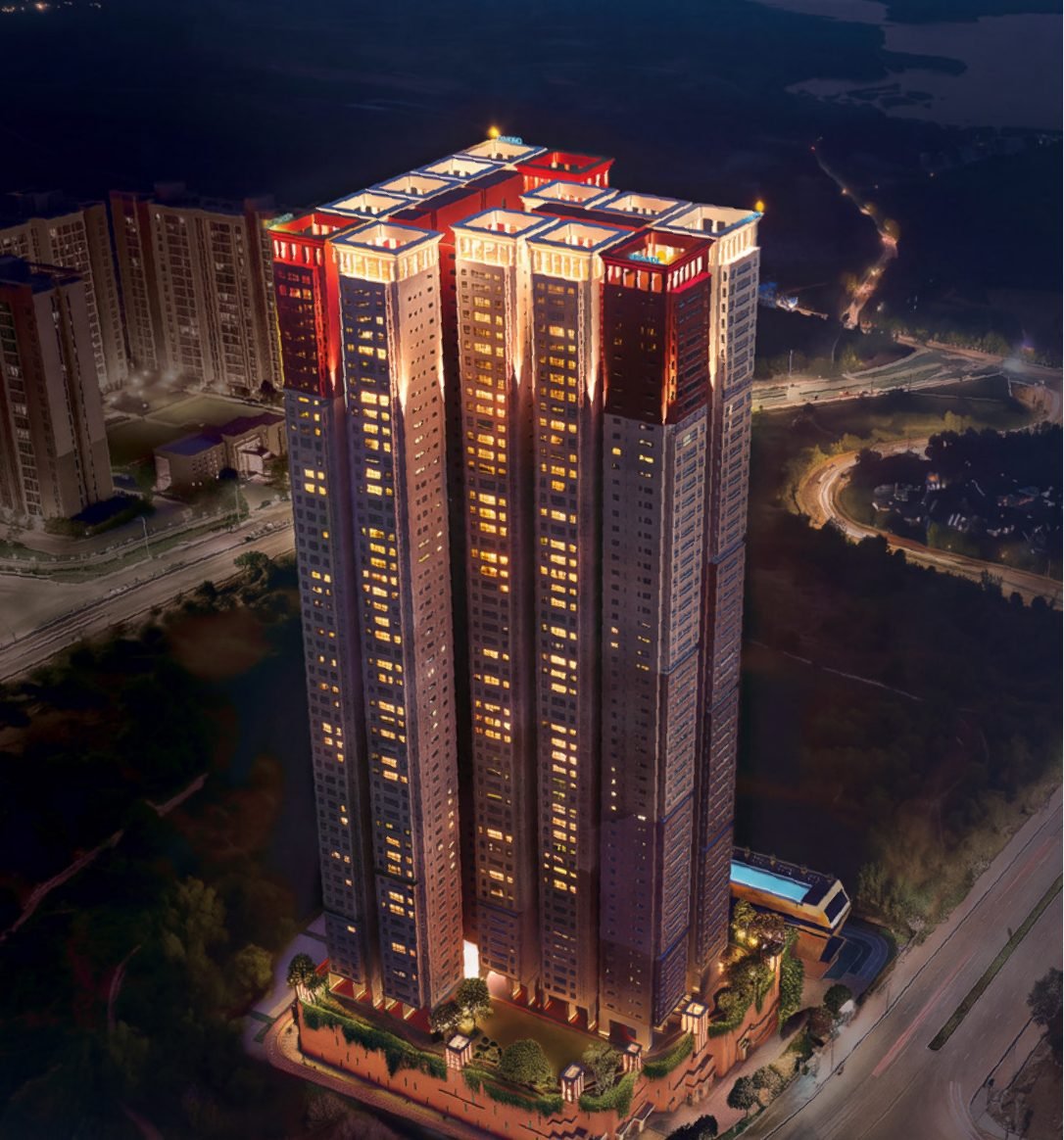 Brigade Barcelona, Neopolis Kokapet — night aerial render of the high-rise residential tower beside the Outer Ring Road